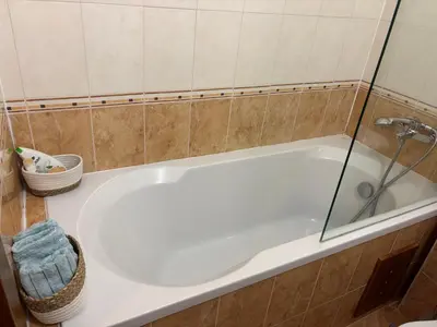 a white bath tub with a glass shower door at Emily Pirin Golf in Razlog
