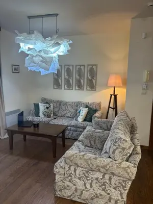 a living room with a couch and a table at Emily Pirin Golf in Razlog