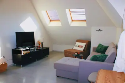 a living room with a couch and a tv at Lucy in Sandanski