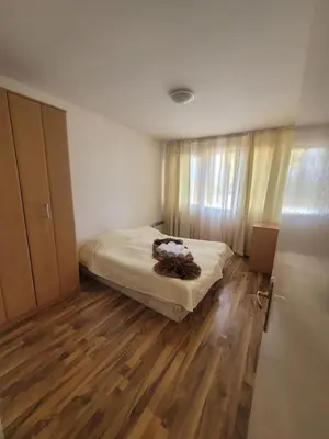 a bedroom with a bed and a wooden floor at Ramada2 Alexander Services Apartments in Bansko