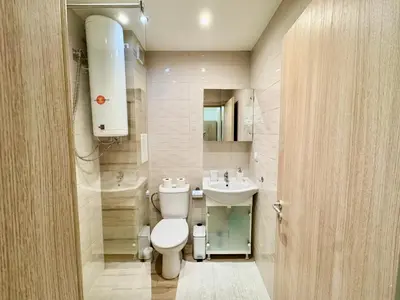 a bathroom with a toilet and a sink at Joyful Studio in Sofia