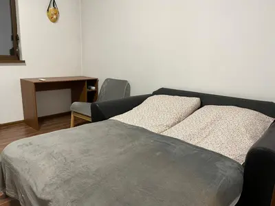 a bedroom with a bed and a desk and a table at Cinema house at Sofia center in Sofia