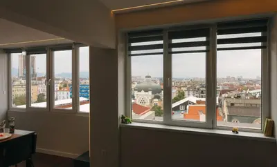 a room with four windows with a view of a city at Serdica Tower View DT Parking Wi-Fi AC in Sofia
