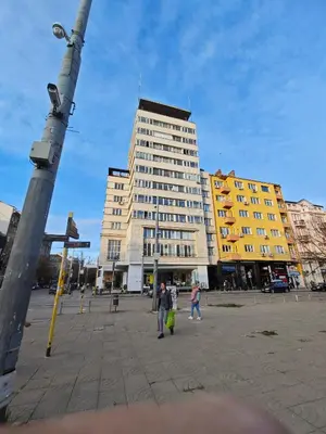 a tall building with people walking in front of it at Serdica Tower View DT Parking Wi-Fi AC in Sofia