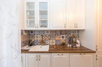 a kitchen with white cabinets and a sink at The Pearl Downtown in Sofia