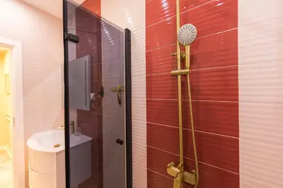 a bathroom with a shower and a sink at The Pearl Downtown in Sofia