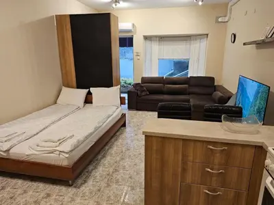 a bedroom with a bed and a living room at Bright and Cozy Studio with Garage near the Center in Sofia