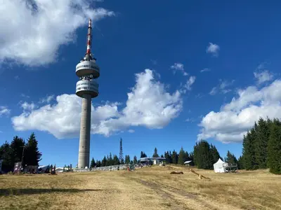 a tower in the middle of a field with a sky at Апартаменти Борови хълмове in Pamporovo