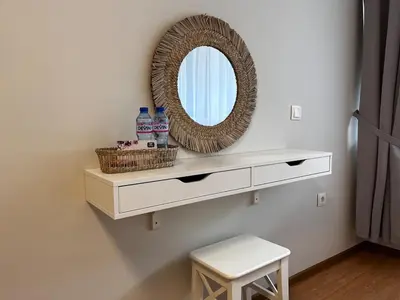 a bathroom with a mirror and a stool and a shelf at TwinStay #6 - Deluxe Super King Suite in Sofia