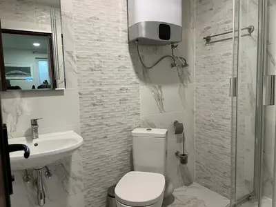 a bathroom with a toilet and a sink and a shower at Sahat Tepe Studio in Plovdiv