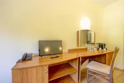a wooden desk with a television on top of it at Hotel Borovets Palace in Borovets