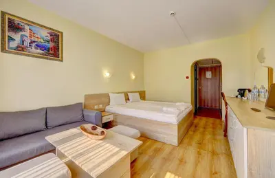 a hotel room with a bed and a couch at Hotel Borovets Palace in Borovets