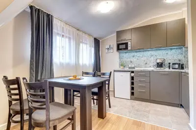 a kitchen and dining room with a table and chairs at Top floor Ski-In Stay in Pamporovo
