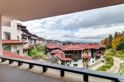 a view of a city from a balcony of buildings at Ski Slope Getaway at Grand Monastery in Pamporovo