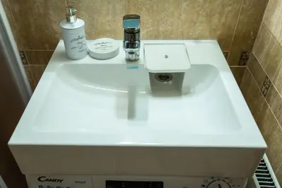 a white sink in a small bathroom with at Cozy and warm apartment with a separate bedroom in Bansko