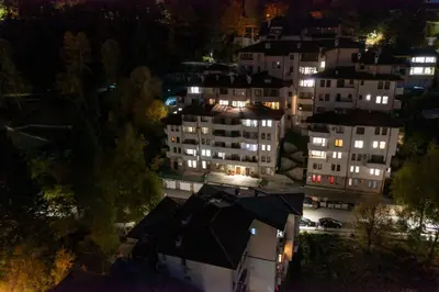 a view of a city at night with illuminated buildings at Апартамент Милена in Smolyan