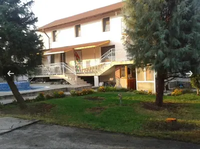 a large white house with stairs and a yard at Country House БатЖоро