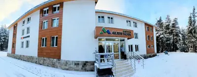 a building with snow on the ground in front of it at Alen Mak in Govedartsi