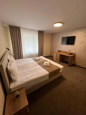 a hotel room with a bed and a television at Alen Mak in Govedartsi