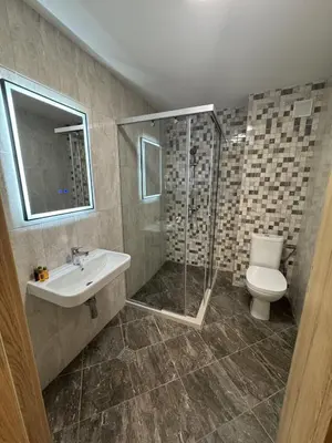 a bathroom with a shower and a toilet and a sink at Alen Mak in Govedartsi