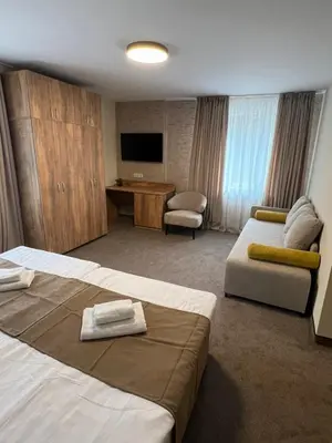 a hotel room with two beds and a television at Alen Mak in Govedartsi