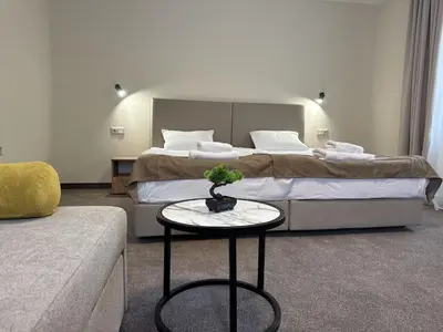 a bedroom with a bed and a table in front of it at Alen Mak in Govedartsi