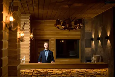 a man in a suit and tie standing on a counter at Grand Resort Pamporovo Apartments in Pamporovo