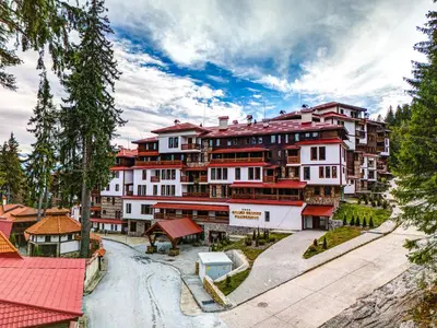a large apartment building with a road in front of it at Grand Resort Pamporovo Apartments in Pamporovo