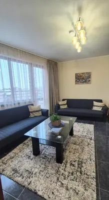 a living room with couches and a coffee table at Elit Apartment - City and Hill view in Plovdiv