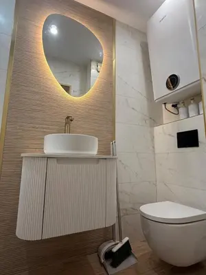 a bathroom with a sink and a toilet and a mirror at Appartement moderne et chic Ski & Spa Bansko in Bansko
