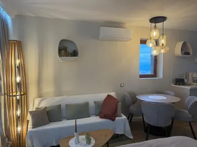 a living room with a couch and a table at Appartement moderne et chic Ski & Spa Bansko in Bansko