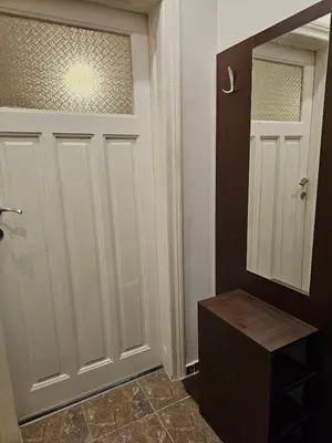 a bathroom with a white door and a mirror at Super Central 2BR FREE Parking in Sofia