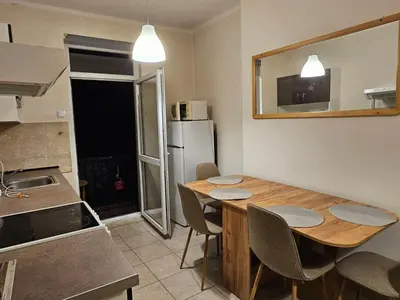 a kitchen with a table and chairs and a refrigerator at Super Central 2BR FREE Parking in Sofia