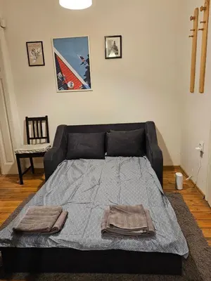 a bed with two towels on it in a room at Super Central 2BR FREE Parking in Sofia