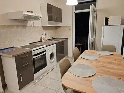 a kitchen with a table and a sink and a stove at Super Central 2BR FREE Parking in Sofia