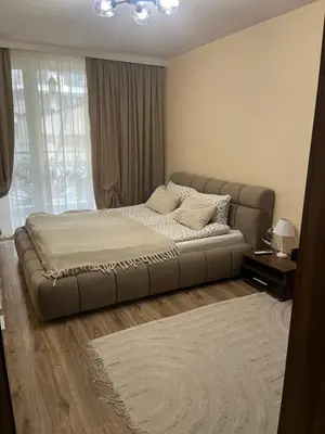 a large bed in a bedroom with a couch at Guest House Amaya Med 2 in Plovdiv