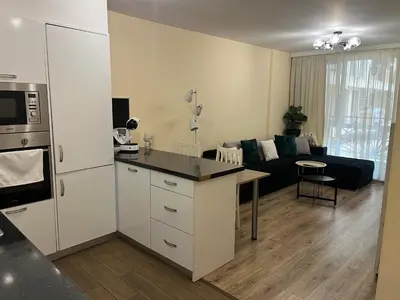 a kitchen and a living room with a couch at Guest House Amaya Med 2 in Plovdiv