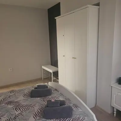 a bedroom with a bed with three pillows on it at Luxury Suite Old Plovdiv with parking in Plovdiv