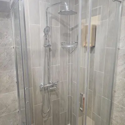 a shower with a glass door in a bathroom at Luxury Suite Old Plovdiv with parking in Plovdiv