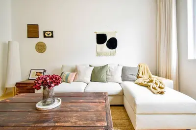 a living room with a white couch and a coffee table at Boho Gem in Sofia
