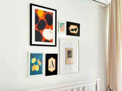 a group of framed art on a white wall at Boho Gem in Sofia