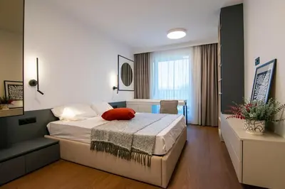 a bedroom with a bed and a couch in it at Alta Vita - Brand New - Luxury - Parking - Wash&Dry - Gas Heating in Sofia