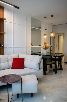 a living room with a white couch and a table at Alta Vita - Brand New - Luxury - Parking - Wash&Dry - Gas Heating in Sofia