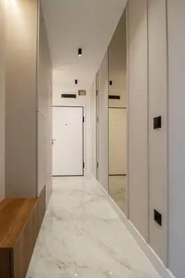 a hallway with white walls and marble flooring at Alta Vita - Brand New - Luxury - Parking - Wash&Dry - Gas Heating in Sofia