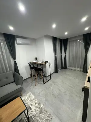 a living room with a couch and a table at Le bijou-Беломорски in Plovdiv