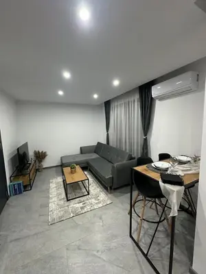 a living room with a couch and a table at Le bijou-Беломорски in Plovdiv