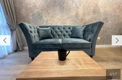a blue couch in a living room with a coffee table at Le bijou-Tomov Plaza in Plovdiv