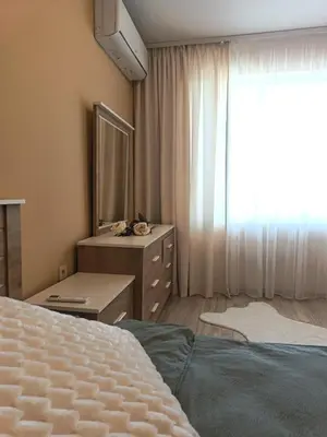 a bedroom with a bed and a dresser and a mirror at Boutique apartment family 5 in Plovdiv