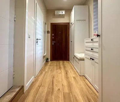 a hallway with wooden floors in a apartment at Heart of Sofia Apartment in Sofia