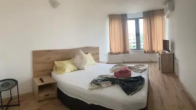 a bedroom with a bed with white sheets and pillows at Casa De Zambini in Plovdiv